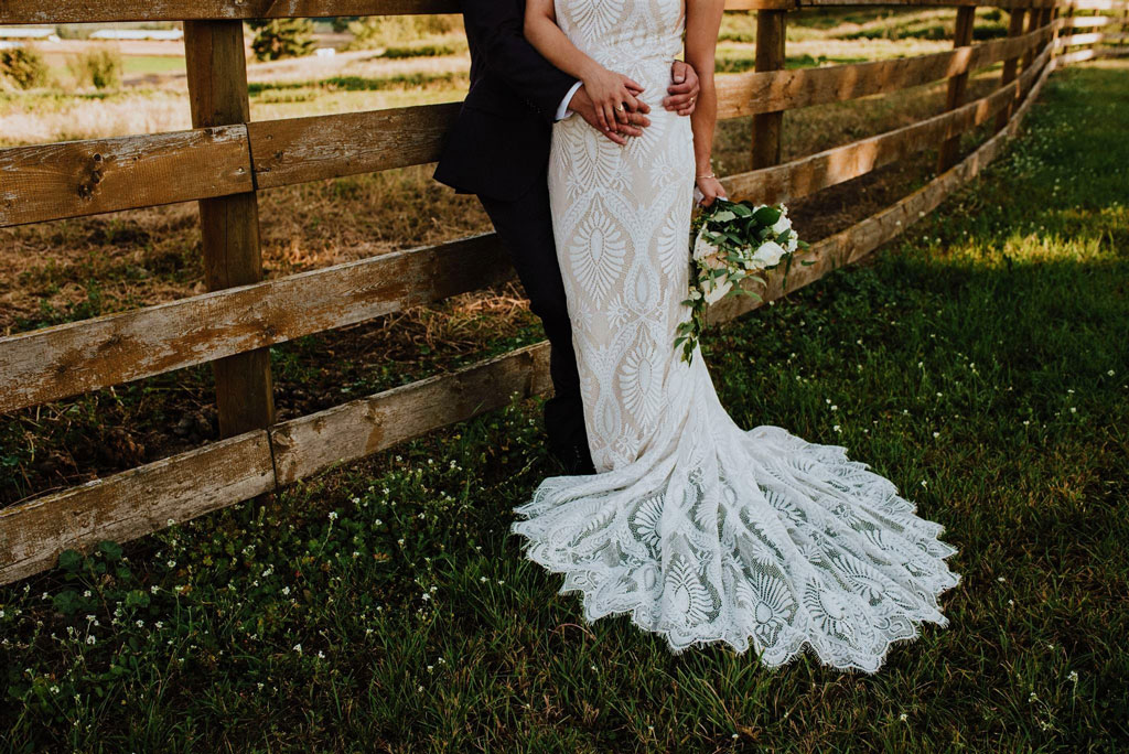 Bride & Groom by Fence